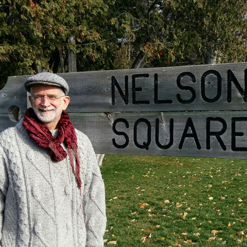 Philip Cable standing at Nelson Square sign